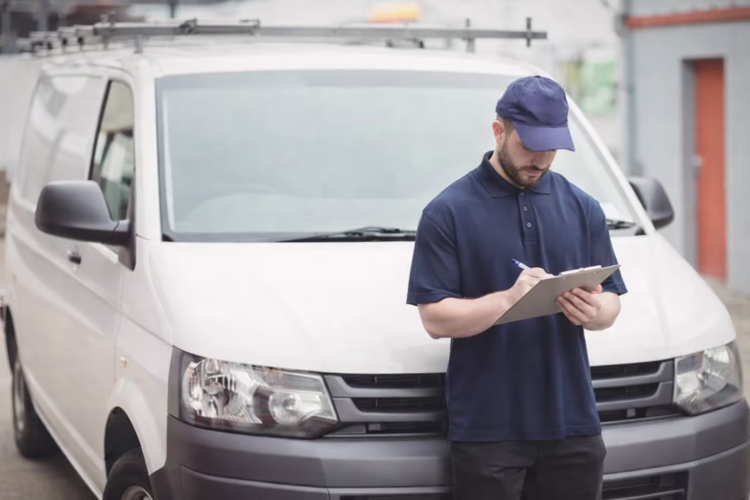FixFinder service technician with clipboard in front of service van